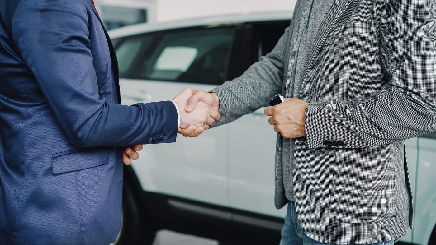 Übergabe eines Fahrzeugschlüssels im Autohaus